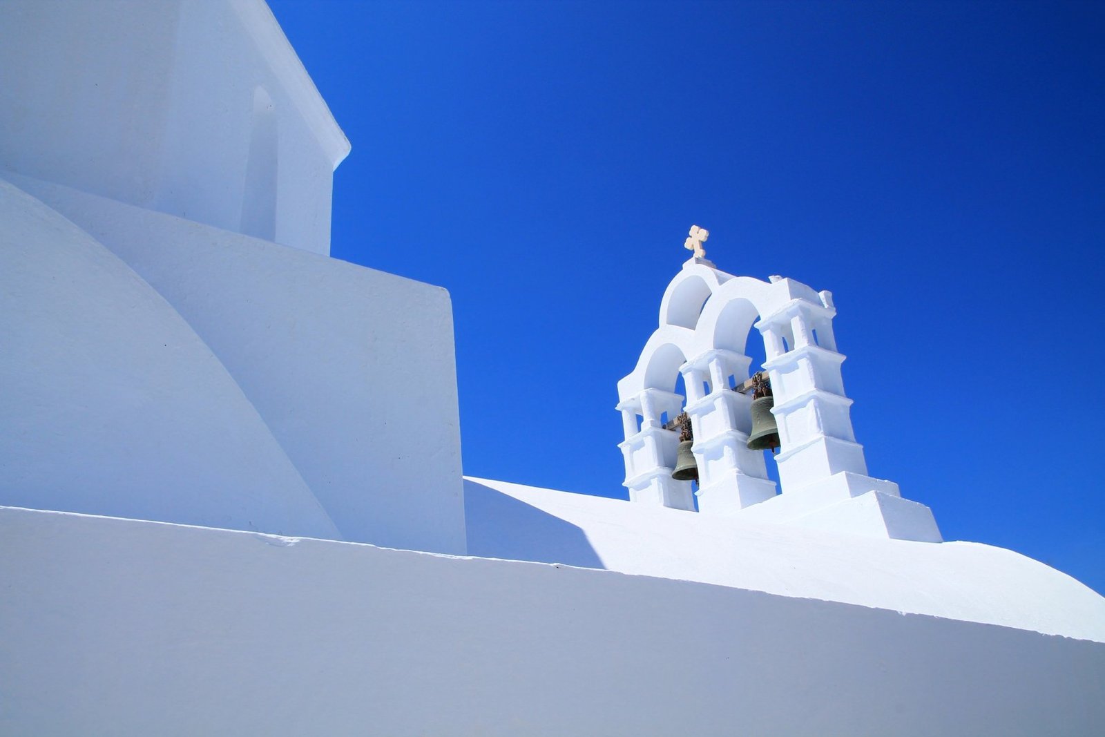 Clocher blanc sous un ciel bleu en Grèce